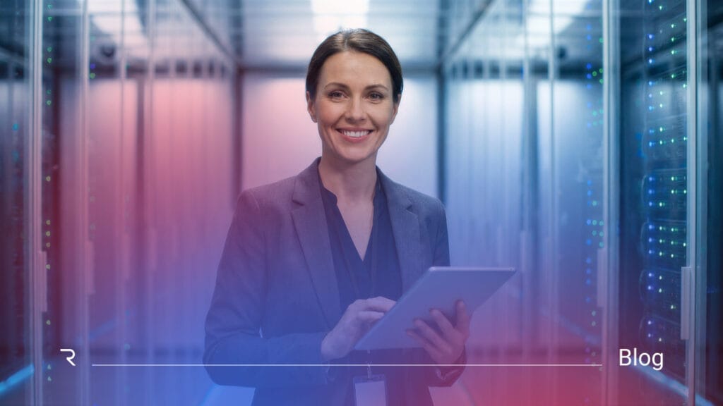 Business professional holding tablet in modern server room with data center infrastructure and digital systems